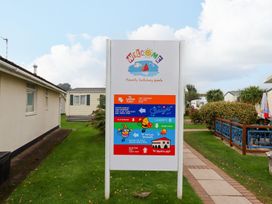 A welcome sign for a family holiday park at Dolphin Chalet Dawlish Warren
