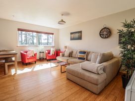 A living room with a sofa and armchairs at Redwood in Harlech
