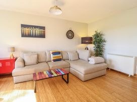 A living room with a sofa and coffee table at Redwood in Harlech