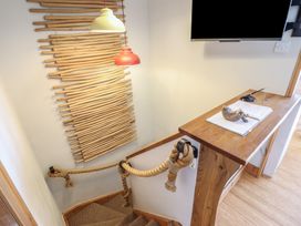 A staircase with a wall decor and desk at Redwood in Harlech