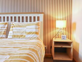 A bedroom with a bed and bedside lamp at Redwood in Harlech
