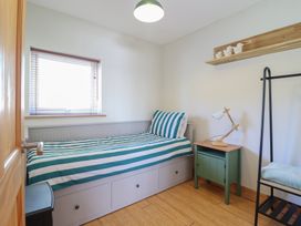 A bedroom with a bed and storage at Redwood in Harlech