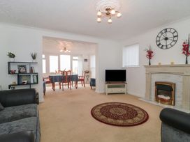 A living room with a sofa and television at Breaking Waves in Burnham-On-Sea