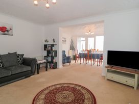 A living room with a sofa and television at Breaking Waves in Burnham-On-Sea