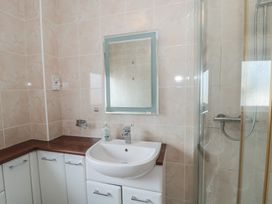 A bathroom with a sink and mirror at Breaking Waves in Burnham-On-Sea