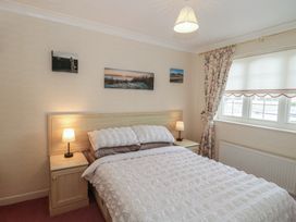 A bedroom with a bed and bedside tables at Breaking Waves in Burnham-On-Sea