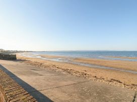 A beach with sand and water at Breaking Waves in Burnham-On-Sea