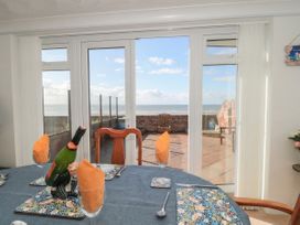 A dining room with a view of the sea at Breaking Waves in Burnham-On-Sea