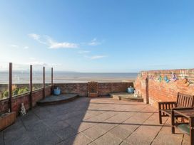 An outdoor patio with a view of water at Breaking Waves in Burnham-On-Sea