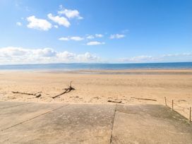 A beach with sand and water at Breaking Waves in Burnham-On-Sea