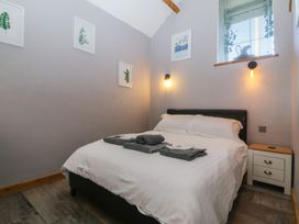 A bedroom with a bed and bedside table at Ty Coch in Llanaelhaearn near Trefor, Caernarfon