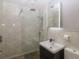 A bathroom with a shower and wash basin at Ty Coch in Llanaelhaearn near Trefor, Caernarfon