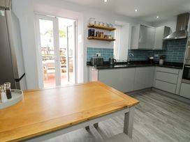 A kitchen with a table and chairs at Y Bwthyn in Llanbedr