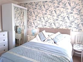 A bedroom with a bed and bedside table at Crooked Well in Timsbury, Nr Bath