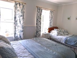 A bedroom with two beds and windows at Crooked Well in Timsbury, Nr Bath