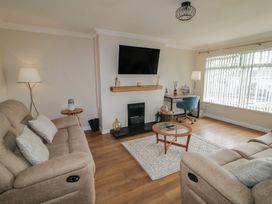 A living room with a sofa and coffee table at Hazel Cottage Portrush