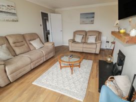 A living room with sofas and a coffee table at Hazel Cottage Portrush
