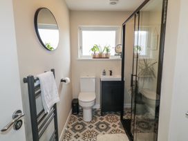A bathroom with a shower, toilet, and sink at Hazel Cottage in Portrush
