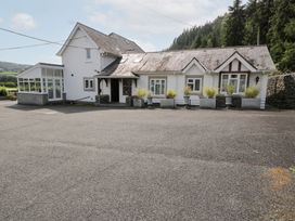 A house with windows and planters at Pengwern in Llanrwst