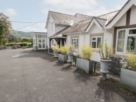 An outdoor area with a house and planters at Pengwern in Llanrwst