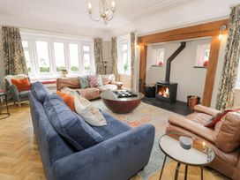A living room with sofas and a fireplace at Pengwern in Llanrwst