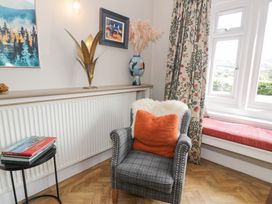 A living room with an armchair and radiator at Pengwern in Llanrwst