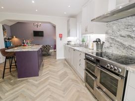 A kitchen with an island and appliances at Pengwern in Llanrwst
