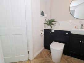 A bathroom with a toilet and sink at Pengwern in Llanrwst