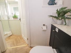 A bathroom with a toilet and sink at Pengwern in Llanrwst
