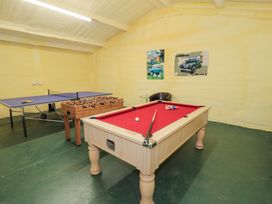 A game room with a pool table and table tennis table at Pengwern in Llanrwst