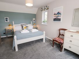 A bedroom with a bed and nightstand at Pengwern in Llanrwst