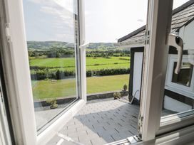 A view from a window overlooking a grassy area at Pengwern in Llanrwst