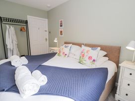 A bedroom with a double bed and bedside table at Pengwern in Llanrwst