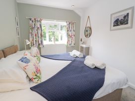 A bedroom with two beds and towels at Pengwern in Llanrwst