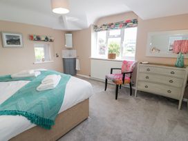 A bedroom with a bed and a dressing table at Pengwern in Llanrwst
