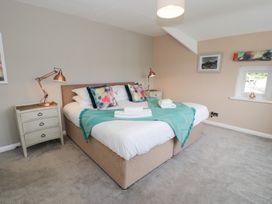 A bedroom with a bed and bedside table at Pengwern in Llanrwst