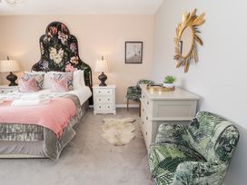 A bedroom with a bed and mirrors at Pengwern in Llanrwst