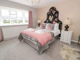 A bedroom with a bed and bedside tables at Pengwern in Llanrwst