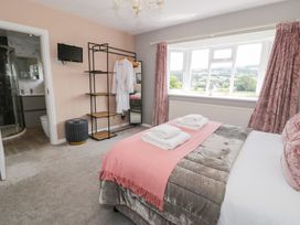 A bedroom with a bed and towels at Pengwern in Llanrwst