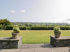 A garden view with planters and hills at Pengwern in Llanrwst