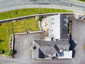 An aerial view of a house with a garden and patio at Pengwern in Llanrwst