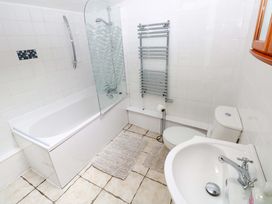 A bathroom with a bathtub, shower, toilet, and sink at The Nook Star near Cenarth