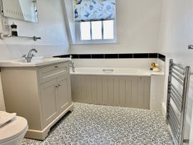 A bathroom with a sink and bath at Seasides in Weymouth