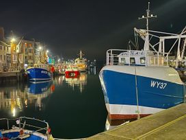 Fishing boats in a harbor at night at Seasides in Weymouth