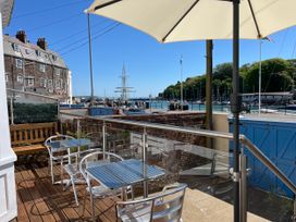 An outdoor seating area with tables and chairs at Seasides in Weymouth