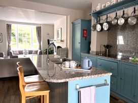 A kitchen with an island and seating at Seasides in Weymouth