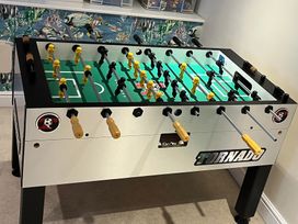 A foosball table with yellow and black players at Seasides in Weymouth