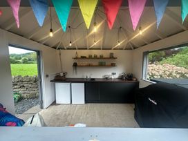 A kitchen with cabinets and appliances at The Coach House in Ross-On-Wye