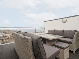 An outdoor terrace with seating and a table at 5 Quay Court in Newquay