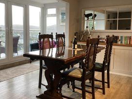 A dining room with a table and chairs at Windwhistle in Dartmouth
